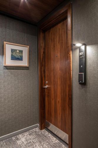 a wooden door in a room with a picture on the wall at Elevation Lofts Hotel in Asheville