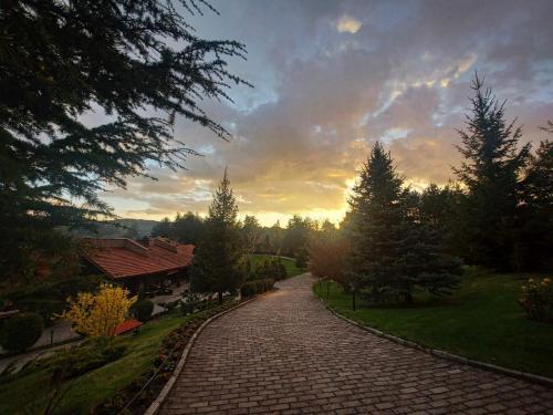 a brick road with a sunset in the background at Aurora Resort & Spa in Berovo