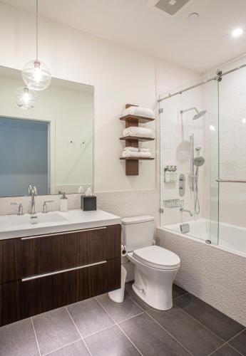a bathroom with a toilet and a sink and a shower at Elevation Lofts Hotel in Asheville