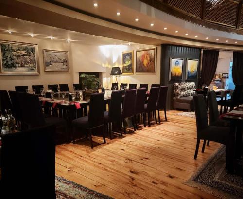 a restaurant with tables and chairs in a room at Aurora Resort & Spa in Berovo