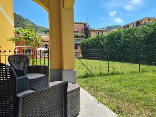 a porch with chairs and a field of grass at Santa Caterina in Levanto