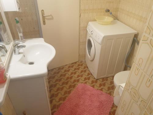 a bathroom with a sink and a washing machine at Apartments & Rooms Zlatica Hvar in Hvar