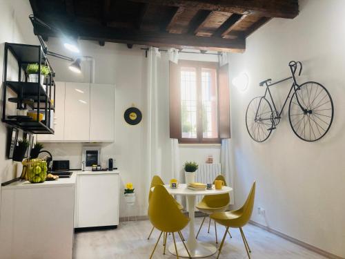 cocina con mesa y bicicleta colgada en la pared en Bike&The City, en Ferrara