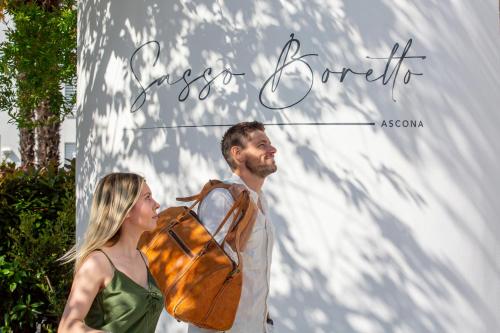 a man and a woman standing in front of a sign at Sasso Boretto, Luxury Holiday Apartments in Ascona