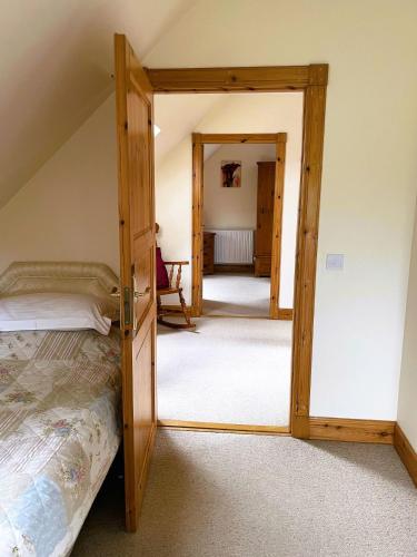 a bedroom with a bunk bed and a mirror at Deveron Valley Cottages in Marnoch
