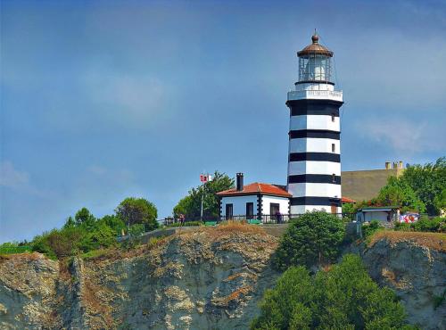 a lighthouse sitting on top of a cliff at Bodega Butik Otel Şile in Sile