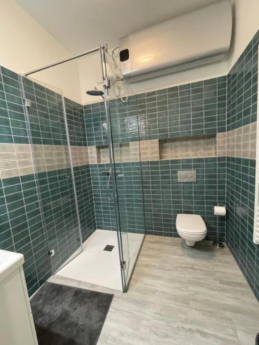 a bathroom with a glass shower and a toilet at Astoria Downtown Superior in Budapest
