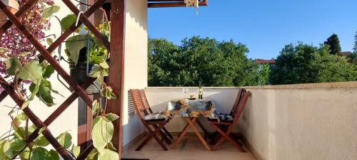 a table and chairs sitting on a balcony at Green Villa in Banjole