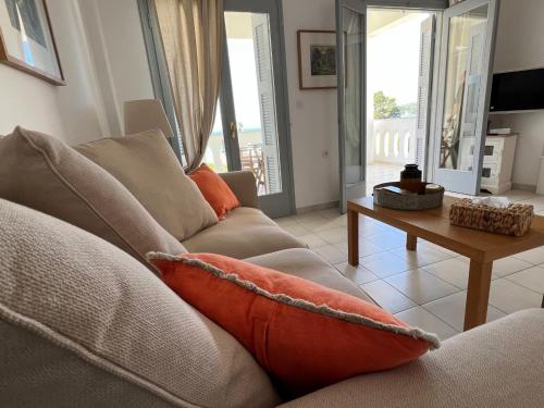 a living room with a couch and a table at Bakagiannis Apartments in Parga