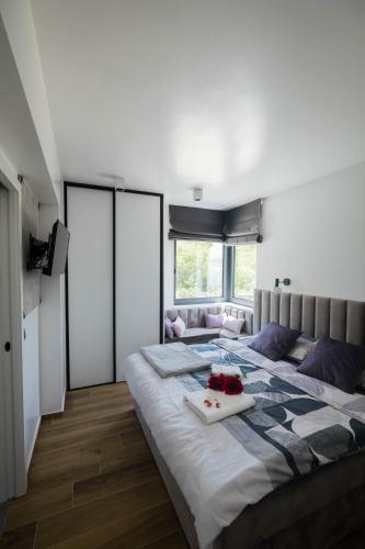 a bedroom with a large bed with a tray of fruit on it at Villa Skrisia in Cesarica