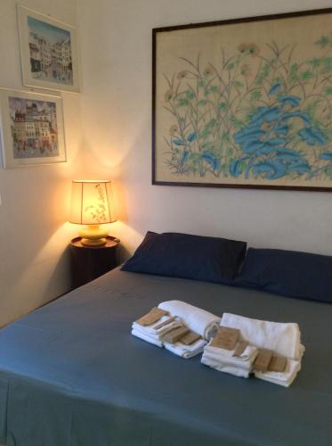 a bedroom with a bed with towels on it at La Casa di Renata by PortofinoVacanze in Rapallo