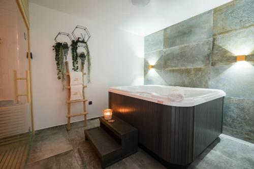 a bathroom with a bath tub and a sink at Villa Skrisia in Cesarica