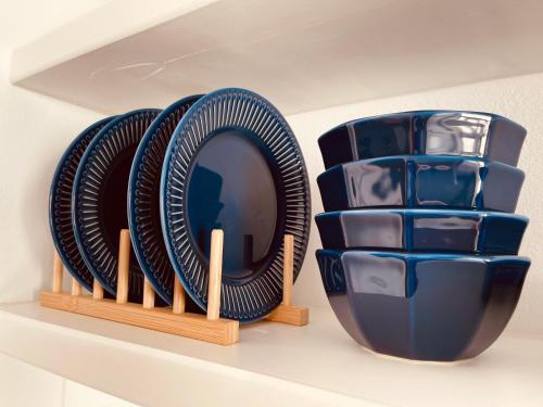 a shelf with plates and bowls on a shelf at Casa Di Manto Traditional Apartment in Mýkonos City