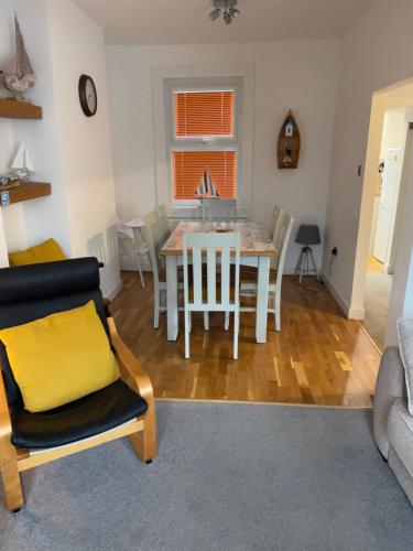 a kitchen and dining room with a table and chairs at Eleven Upway Street in Weymouth