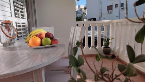 a bowl of fruit on a table on a balcony at Isabella Modern flat City Center Nicosia in Nicosia