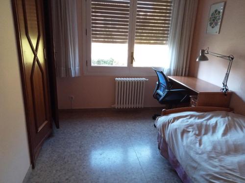 a bedroom with a desk and a bed and a desk and a chair at Cal Kim in Martorell
