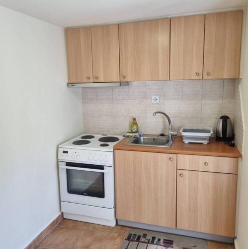 a kitchen with a white stove and a sink at Evi's touch 1 in Poros