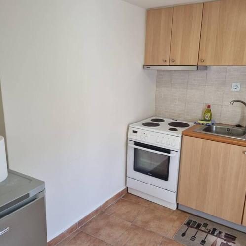 a kitchen with a white stove and a sink at Evi's touch 1 in Poros