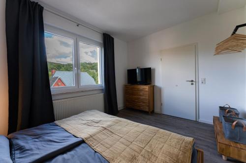a bedroom with a bed and a large window at Ferienwohnung am Steinbach 1 in Thale