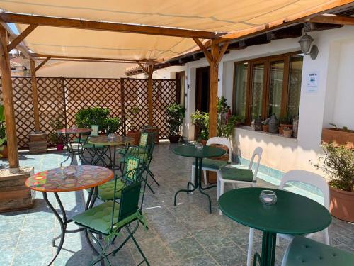 a patio with tables and chairs and a fence at Guest house Le Sibille in Taormina