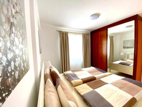 a bedroom with a bed and a large window at Ocean Golf & Country Club J&K in San Miguel de Abona