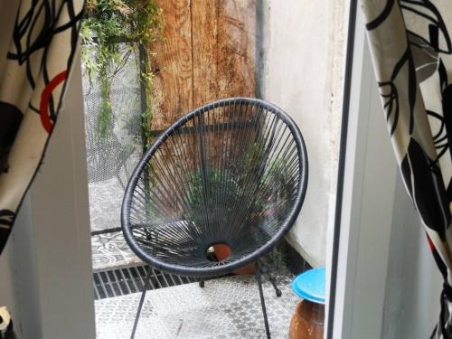a metal chair sitting on a porch outside a door at Apartments Kremenic in Cres