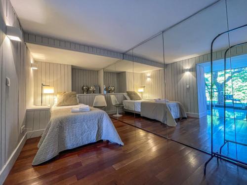 a room with two beds and a mirror at Aqueduct Casa 11 in Lisbon