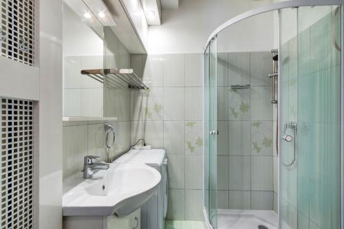 a bathroom with a sink and a glass shower at Károlyi street - central location quiet place 2ppl in Budapest