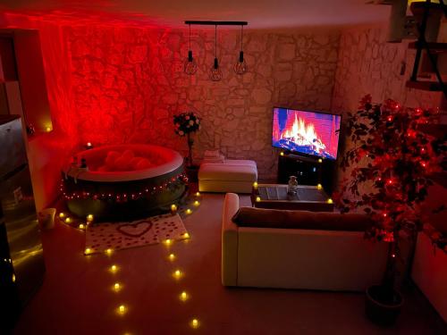 a living room with a tub and a fire place at La maison jacuzzi - Privatiser une soirée jacuzzi in Mandres-les-Roses