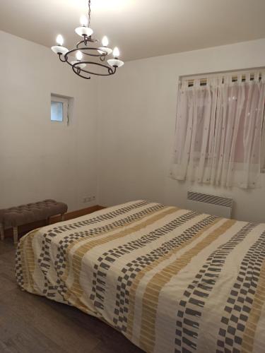 a bedroom with a large bed with a striped blanket at Joss Nath homes in Melun
