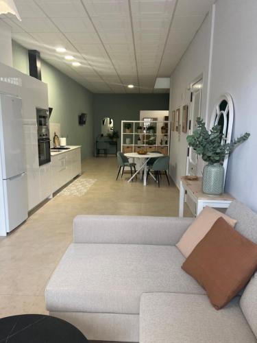 a living room with a couch and a kitchen at Estudio canela in Melilla