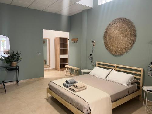 a bedroom with a bed and a fan on the wall at Estudio canela in Melilla