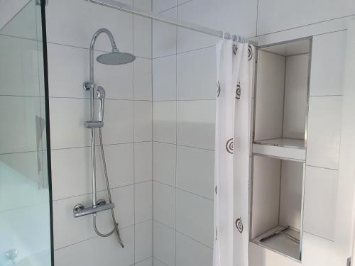 a bathroom with a shower with a shower curtain at ***FeWo Am Achterwasser *** in Lütow