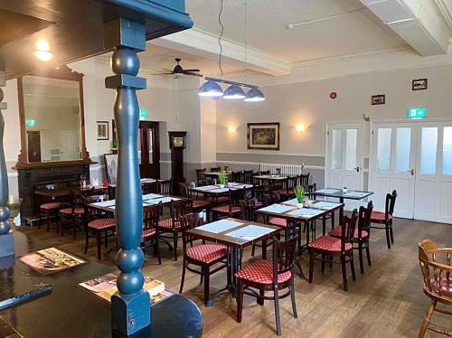 a restaurant with tables and chairs in a room at Royal Hotel Sheerness in Sheerness