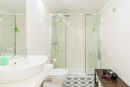 a bathroom with a shower and a toilet and a sink at Hello Porto Firehouse in Porto