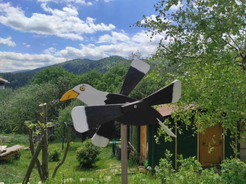 a statue of a bird on a pole in a yard at Zakątek Włóczykija in Cisna