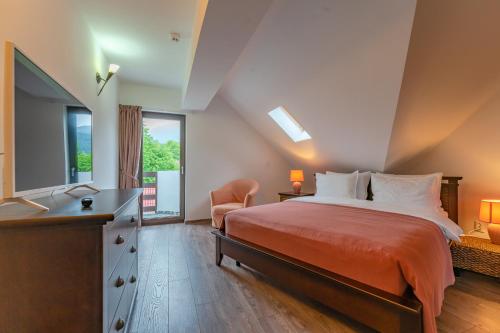 a bedroom with a bed and a dresser and a window at Vila Trubadur - Adults Only in Bran