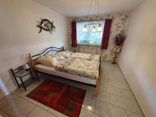 a bedroom with a bed and a window at Ferienhaus Margarete in Dankerode