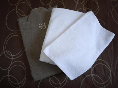 a pile of white napkins with a symbol on it at Hotel Select Inn Shikoku Chuo in Shikokuchuo
