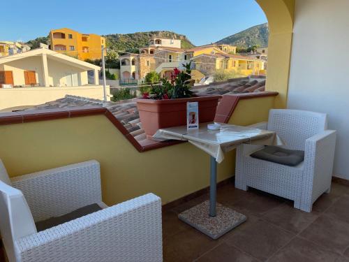 a balcony with a table and chairs and a view at Janas B&B in Posada