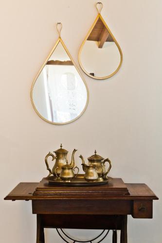 a table with two tea pots and a mirror at ViLLA SYMONE in Afiartis