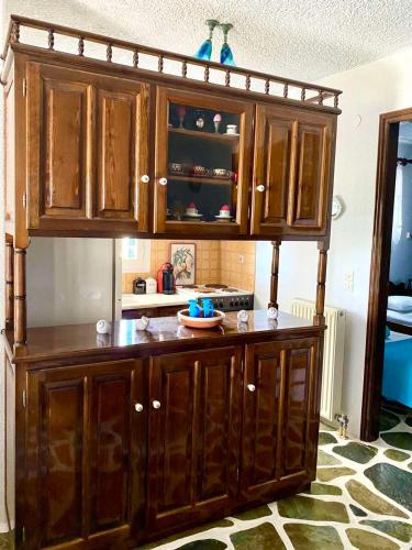 a kitchen with a large wooden cabinet in a room at Gaia home in Prodromos Paros