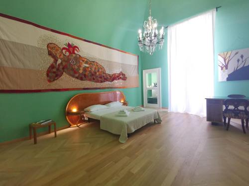 a bedroom with a bed and a painting on the wall at Speciale Tarshito Guesthouse Bari in Bari