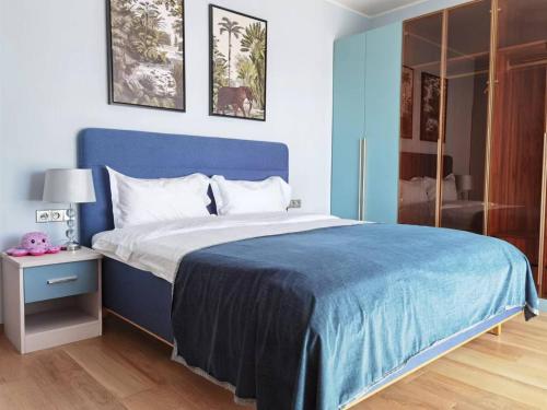 a bedroom with a blue bed with a blue blanket at yipin villa in Prague