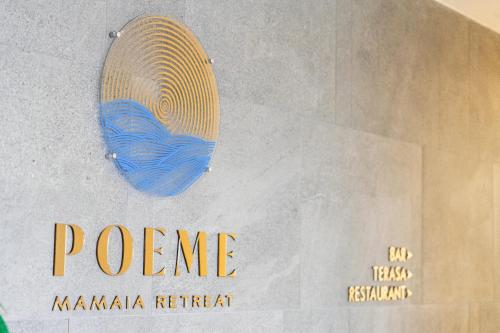 a sign that says porene on a wall at Poeme Mamaia Retreat in Mamaia