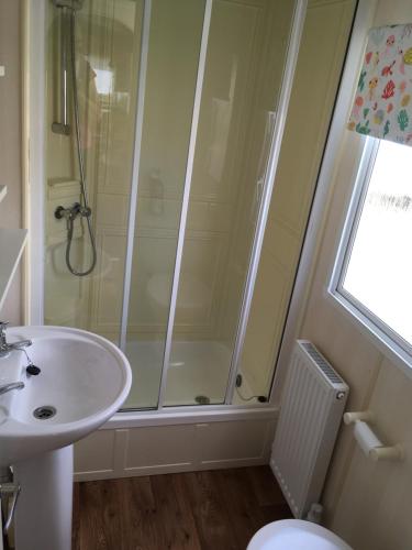 a bathroom with a shower and a sink at Sea Breeze at Winthorpe Skegness in Skegness