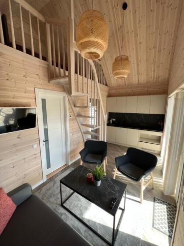 a living room with a couch and a table at Apartamentai “Kuršių Snauda” in Palanga