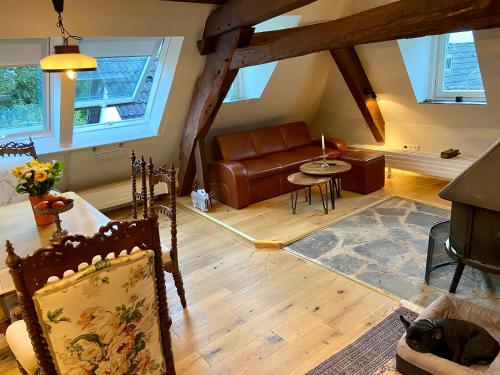a living room with a couch and a table at Burg Maisonette im Posthalterhof mit Sauna in Blankenheim