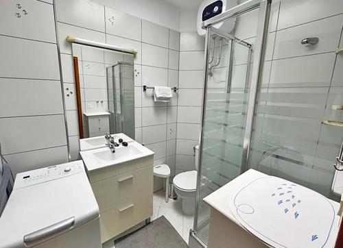 a bathroom with a shower and a sink and a toilet at Ocean Kiss Apartment in Puerto del Carmen