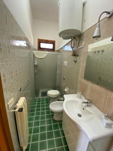 a bathroom with a white sink and a toilet at Holiday home Mediterraneo in Marsala